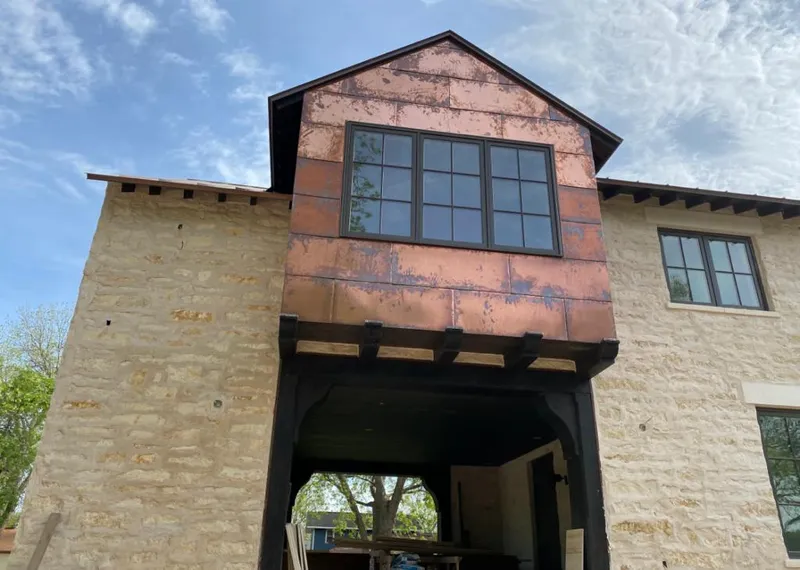 Copper metal panel facade on a stone building for Skylight Installation in Brewton